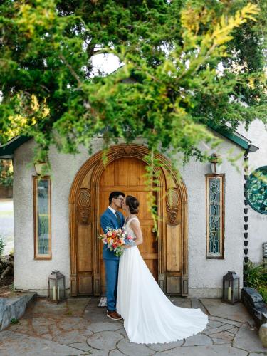 a bride and groom standing in front of a door at New Park Venue & Suites in Ithaca