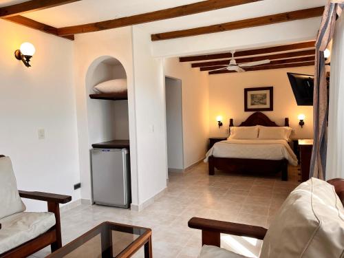a bedroom with a bed and a couch in a room at Hotel Olimpia in Ostende