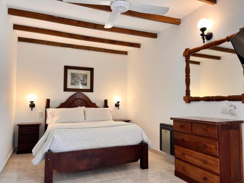 a bedroom with a large bed and a ceiling at Hotel Olimpia in Ostende