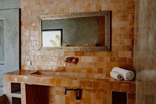 a bathroom with a sink and a mirror at Villa de luxe in Marrakech