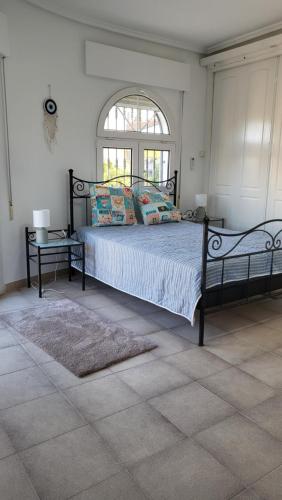 a bedroom with a large bed and a window at Casa Valdi, fantastic 4 bedroom house with private,heated swimming pool and barbecue in Ciudad Quesada