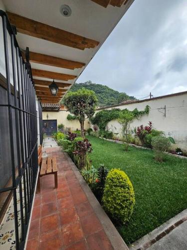a porch of a house with a garden at Restful Hideaway near Antigua in Antigua Guatemala