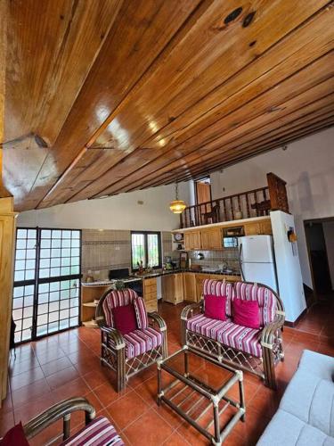 a living room with two chairs and a kitchen at Restful Hideaway near Antigua in Antigua Guatemala