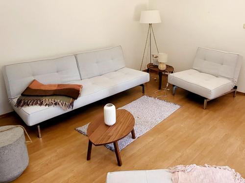 a living room with a white couch and a table at Beachbungalow in Karlshagen