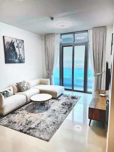 a living room with a couch and a table at Al Reem Breeze in Abu Dhabi
