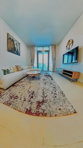 a large living room with a couch and a table at Al Reem Breeze in Abu Dhabi
