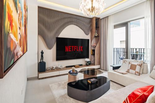 a living room with a couch and a tv at Modern Apartment in Dubai Creek Harbour By DuStay in Dubai