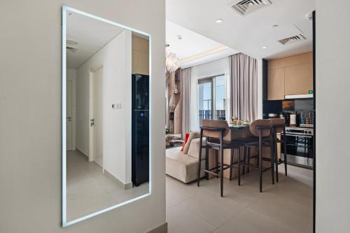 a mirror reflecting a kitchen and a living room at Modern Apartment in Dubai Creek Harbour By DuStay in Dubai