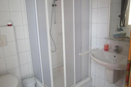 a bathroom with a shower and a sink at Haus-Sahrensdorf in Fehmarn
