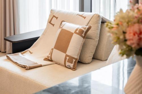 a pillow on a couch in a living room at Modern Apartment in Dubai Creek Harbour By DuStay in Dubai