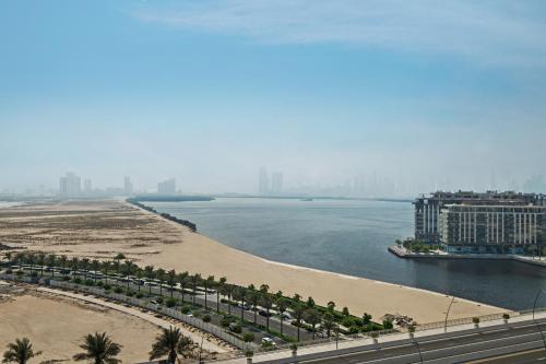 a view of a beach and a body of water at Modern Apartment in Dubai Creek Harbour By DuStay in Dubai