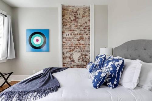 a bed with blue and white pillows and a target at Luxury home in the historic Fan District in Richmond