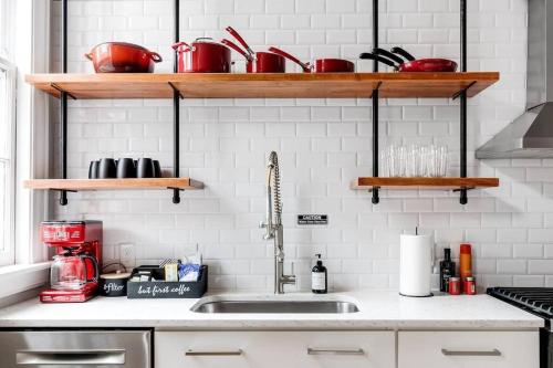 a kitchen counter with a sink and shelves at Luxury home in the historic Fan District in Richmond