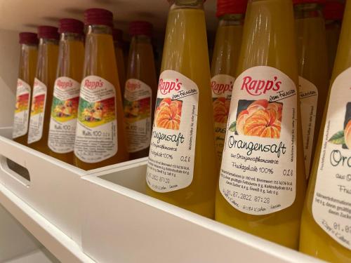 a refrigerator filled with bottles of orange juice at Steffens Herrnmuehle in Alzenau in Unterfranken