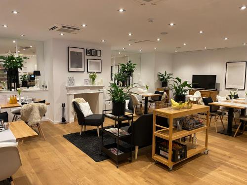 a room filled with tables and chairs with plants at Steffens Herrnmuehle in Alzenau in Unterfranken