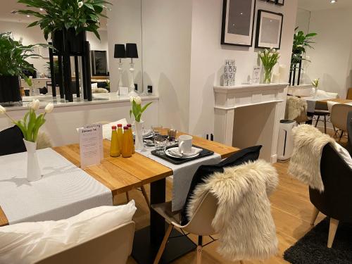a dining room with a table and chairs with fur at Steffens Herrnmuehle in Alzenau in Unterfranken