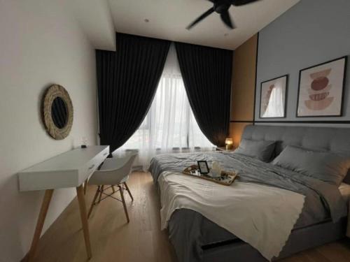 a bedroom with a bed and a desk and a ceiling fan at Luxury Suite Lucentia BBCC Infinity Pool in Kuala Lumpur