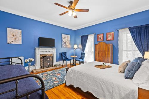a blue bedroom with a bed and a fireplace at The Steamboat Inn in Jefferson