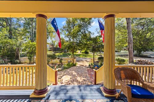 a porch with two flags and two chairs at The Steamboat Inn in Jefferson