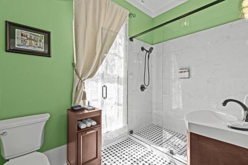 a green bathroom with a shower and a sink at The Steamboat Inn in Jefferson