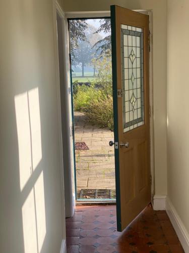 an open door with a view of a yard at The Little Haven in Bakewell in Bakewell