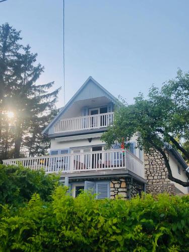 a large white house with a balcony on it at Villa Julia in Velence