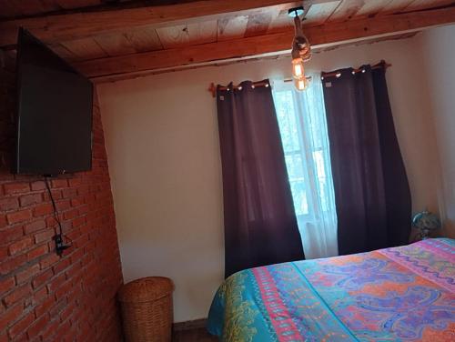 a bedroom with a bed and a window with curtains at Acogedora cabaña cerca del desierto de los leones y CC santa Fe in Mexico City
