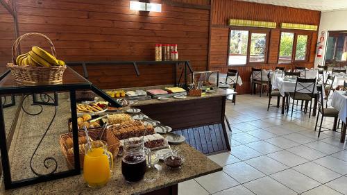 a buffet in a restaurant with food on a table at Pousada Canela Garden in Canela