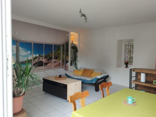 a living room with a couch and a table at vaste T2 en Auvergne in Vic-le-Comte