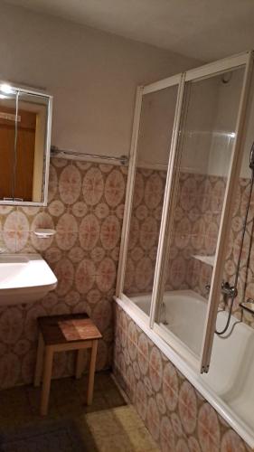 a bathroom with a shower and a sink and a tub at Haus in den Bergen in Borgonovo
