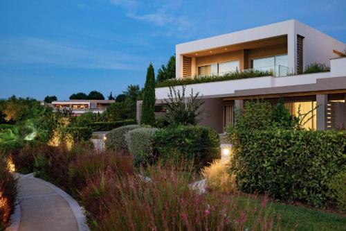a house with a garden in front of it at Sani Dunes in Sani Beach
