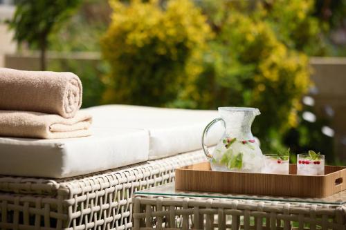 a wicker table with a vase on top of it at Sani Dunes in Sani Beach