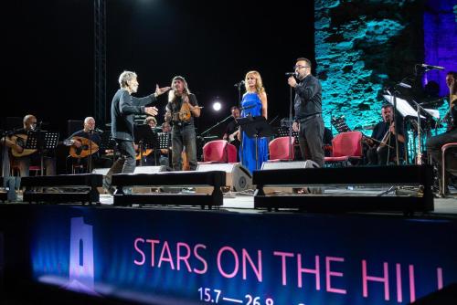 a group of people on a stage with a concert at Sani Dunes in Sani Beach