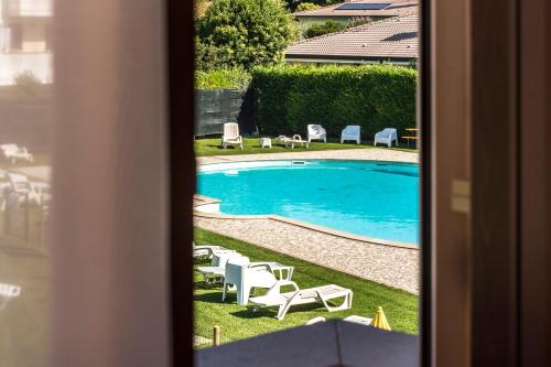 a view of a swimming pool from a window at Hotel Residence - Il Giardino del Cigno in Latisana