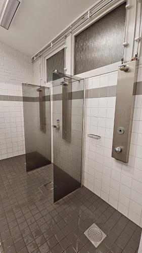 a bathroom with a shower with stalls in it at Kallhällsbaden Strandhotell in Stockholm