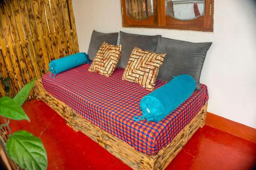 a couch with pillows on it in a room at Moshi hostel lodge in Msaranga