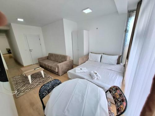 a small room with a bed and a couch at Rooms & Apartment Struga in Struga