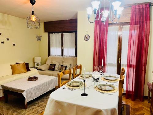 a living room with two tables and a couch at Senda de las mariposas Vinuesa in Vinuesa