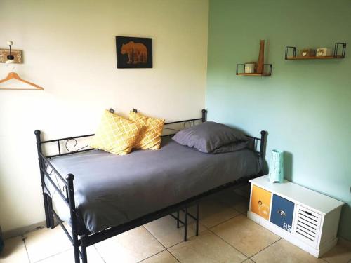 une chambre avec un lit avec des oreillers dessus dans l'établissement Le Studio Charmant à 20min de Paris, à Villennes-sur-Seine