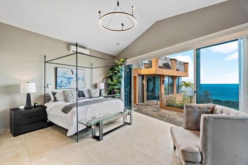 a bedroom with a large bed and a view of the ocean at Luxury Retreat Oceanview w Fitness Studio in Playa Hermosa