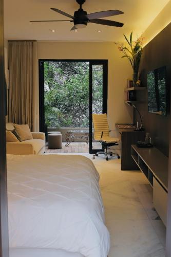 a bedroom with a bed and a large window at Casa Mannach in Mexico City