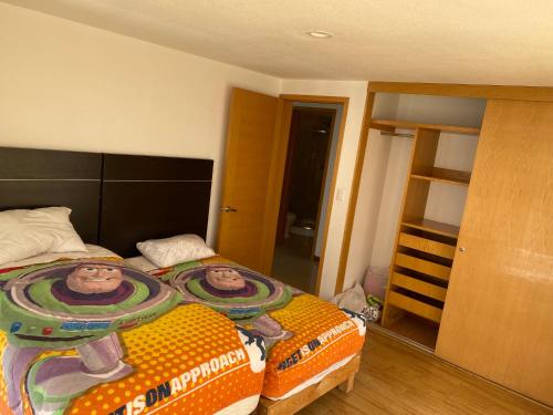 a bedroom with a bed with two people on it at Departamento en zona Angelopolis in Puebla