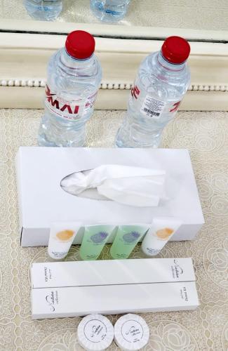 two bottles of water sitting on a table at Cheap Holiday Homes in Ajman
