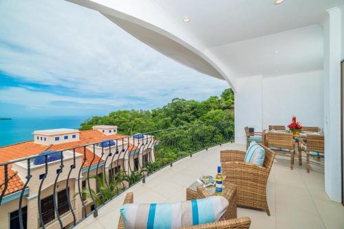 a balcony with chairs and a view of the ocean at Oceanviews, Private Veranda, 2 Pools & Concierge in Playa Flamingo