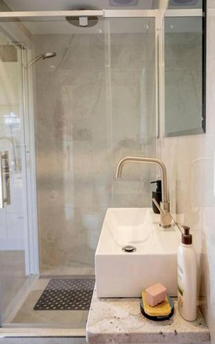 a bathroom with a sink and a shower at One77 Rural Retreat in Matarawa