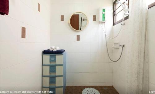 a bathroom with a shower with a mirror at HomeSweetHome in Hang Dong