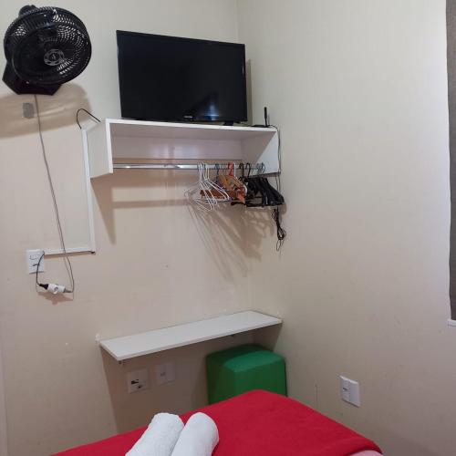 a room with a bed and a tv on a wall at SETTA'S HOSTEL in Sao Paulo