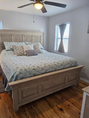 a bed in a bedroom with a ceiling fan at Living the Dream 2 Bedroom Ocean View Cozy Condo in Gulf Shores