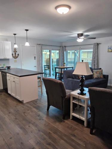 a kitchen and living room with a couch and a table at Living the Dream 2 Bedroom Ocean View Cozy Condo in Gulf Shores