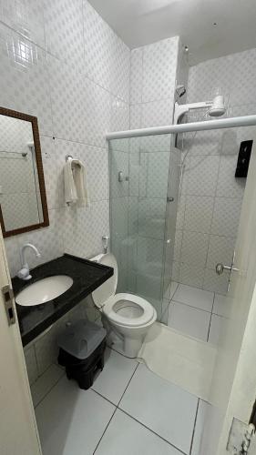 a bathroom with a shower and a toilet and a sink at Flats Duplex Super Aconchegantes e Confortáveis in Maragogi
